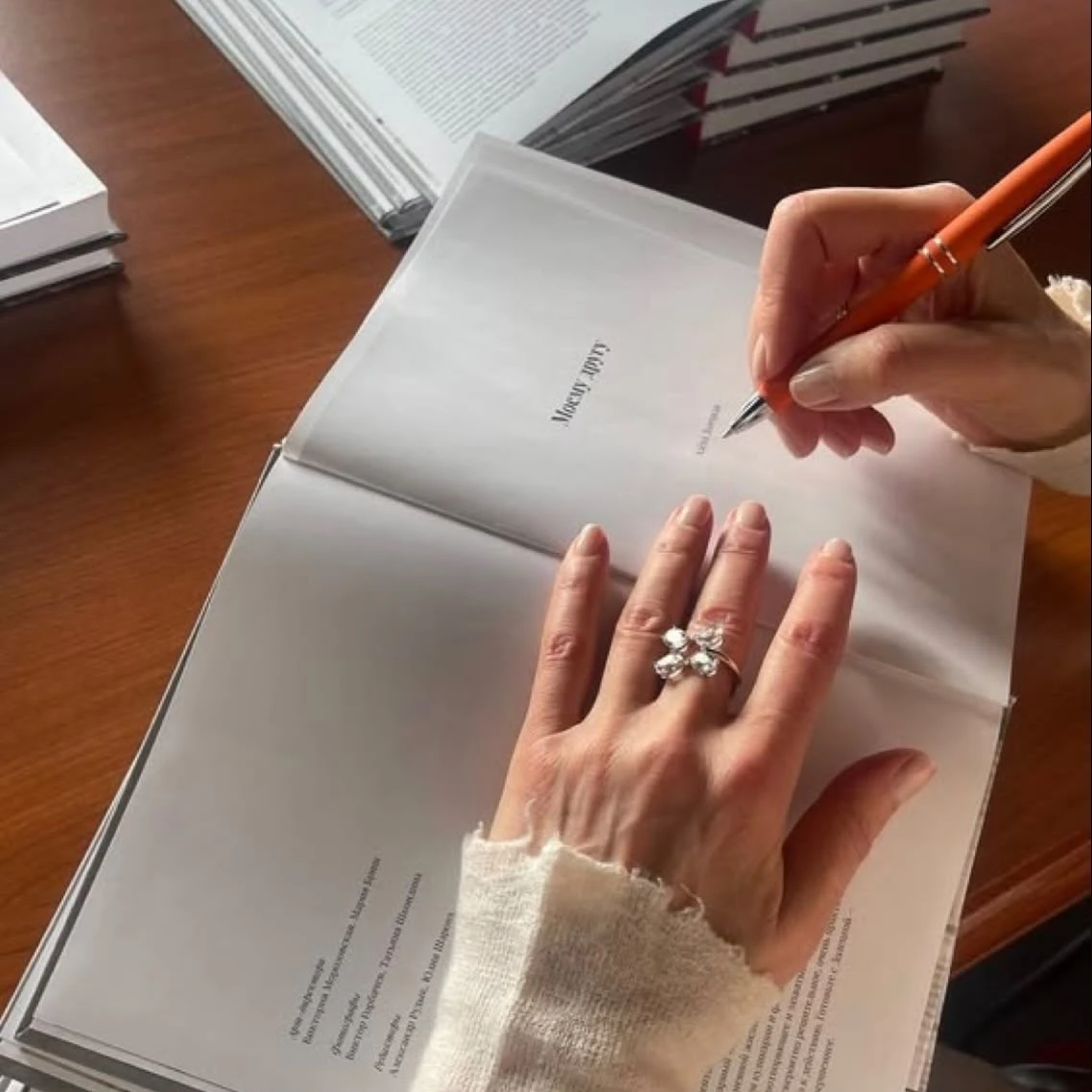 A hand resting on an open book